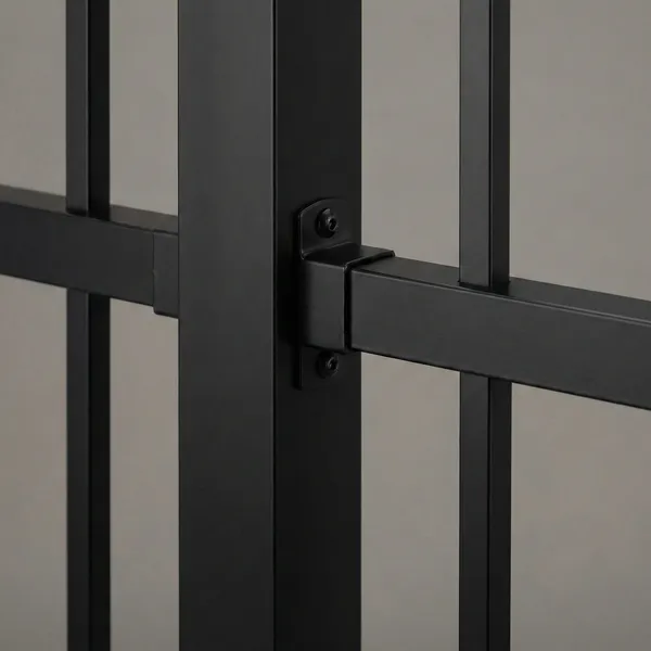 Close-up detail of a matte black aluminum fence showing the secure bracket connection between vertical post and horizontal rail with visible mounting screws.